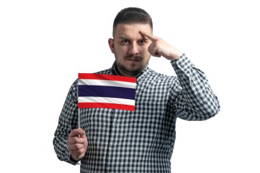 White guy holding a flag of Thailand and a finger touches the temple on the head isolated on a white background.