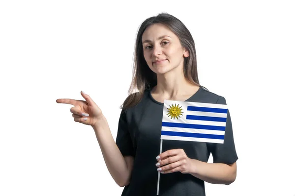 Happy Young White Woman Holding Flag Uruguay Point Left Isolated — Stok Foto