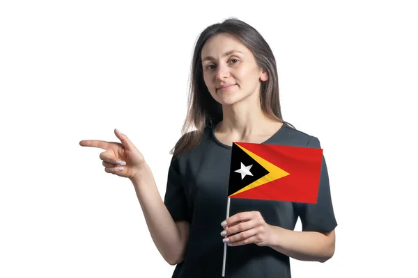 Happy Young White Woman Holding Flag East Timor Points Left — Stock Photo, Image