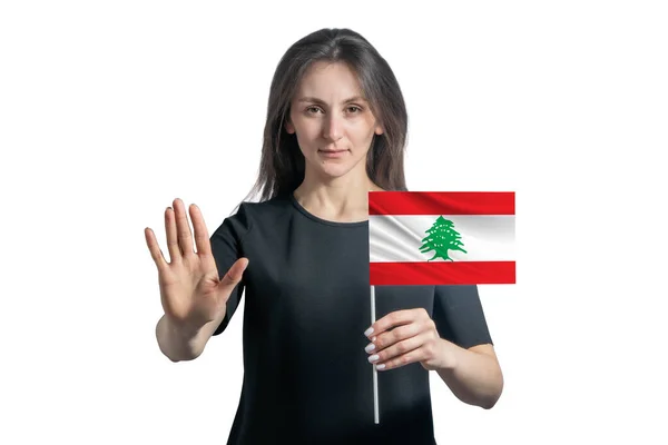 レバノンの旗を掲げる幸せな若い白人女性と深刻な顔は白い背景に孤立した手を止めるサインを示しています — ストック写真
