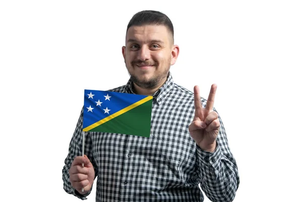 White Guy Holding Flag Solomon Islands Shows Two Fingers Isolated — 图库照片