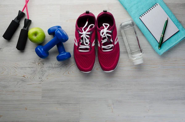 Fitness concept with sneakers dumbbells bottle of water apple and measure tape on wooden table background (0836) — Stock Image Fitness Concept Sneakers Dumbbells Bottle Water Apple Measure Tape Wooden Royalty Free Stock Photos