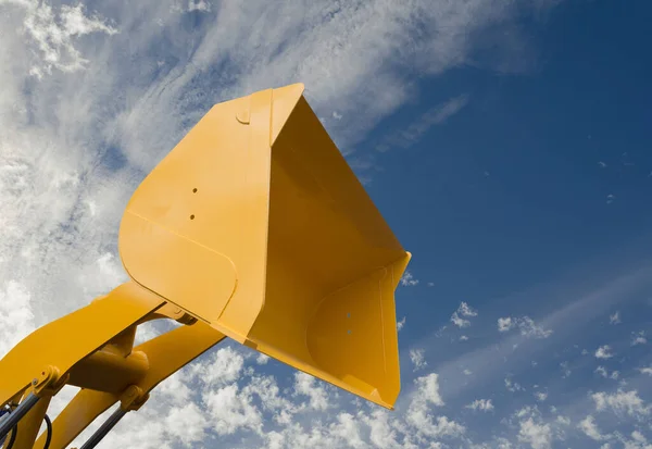 Hydraulic detail of crane arm and basket on sky with clouds background