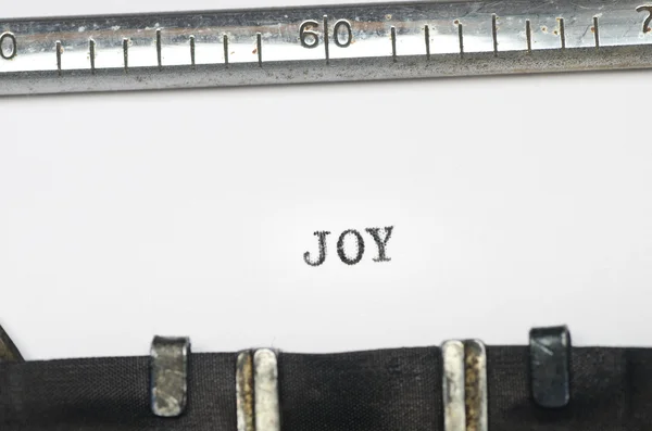Daktiloda yazılmış kelime sevinç — Stok fotoğraf