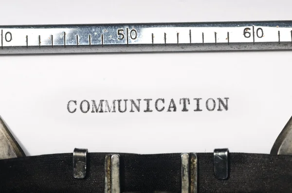 Word communication typed on typewriter — Stock Photo, Image