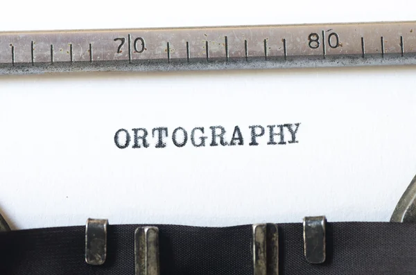 Слово орфографія, введена на друкарській машинці — стокове фото