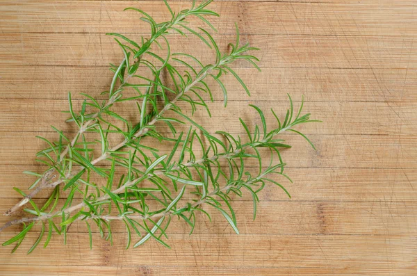 Rosemary twigs on wooden background — Stock Photo, Image