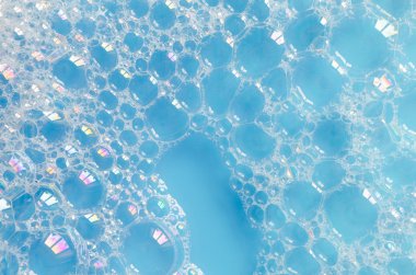 foam bubbles on blue water background clipart