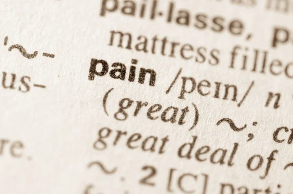 Dictionary definition of word pain — Stock Photo, Image