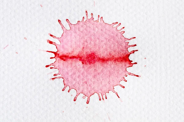 Red watercolor blot on white paper — Stock fotografie