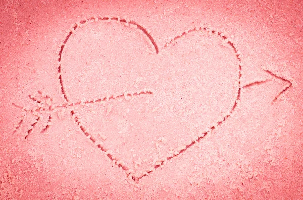 red heart drawing on sand