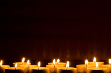 burning candles in darkness clipart