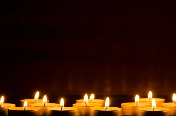 Burning candles in darkness — Stock Photo, Image