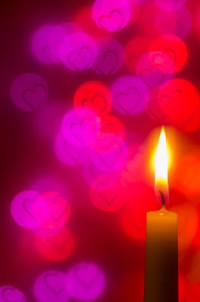 Candle on heart shapes background — Stock Photo, Image