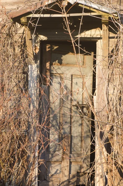 Old front door in abandoned house — Stock Photo, Image