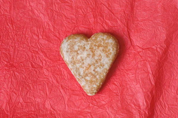 gingerbread heart cookie on red background