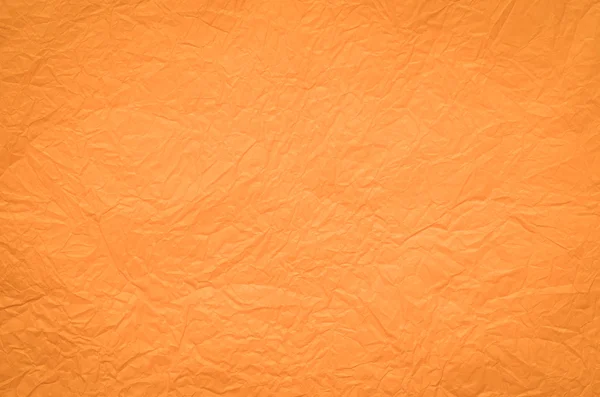 Оранжевый складчатый бумажный фон — стоковое фото