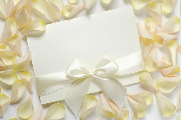 Card with ribbon and rose petals — Stock Photo, Image