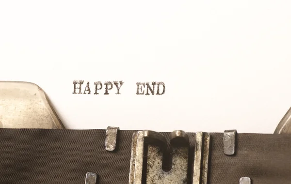 words happy end  written on typewriter