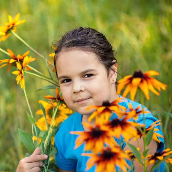 Mała dziewczynka, chodzenie na łące kwiat — Zdjęcie stockowe
