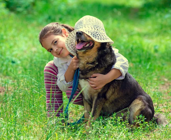 Happy little girl playing with dog — Stock Photo, Image