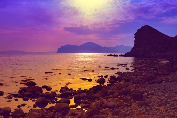 Purple sunset over the beach — Stock Photo, Image