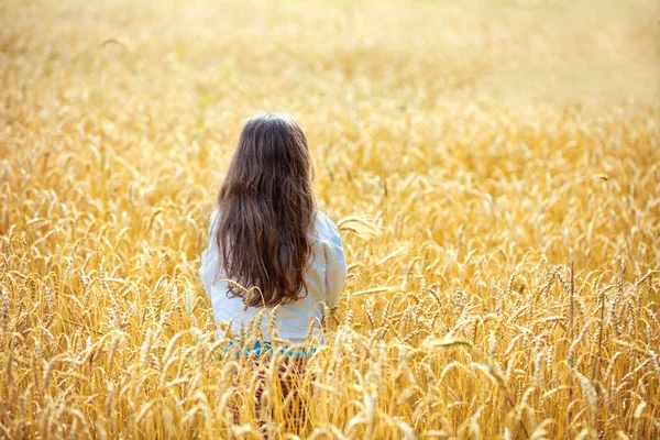 Mädchen bleibt im Weizenfeld — Stockfoto