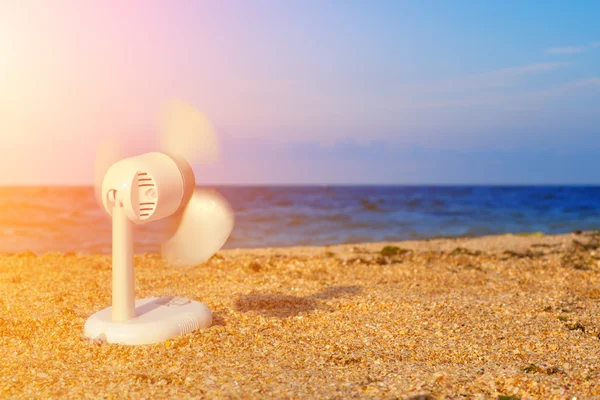 Electric fan blowing on the beach — Stock Photo, Image