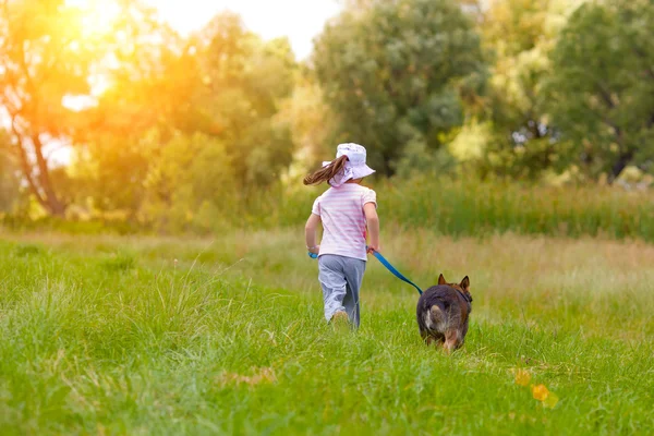 Kleines Mädchen läuft mit Hund — Stockfoto