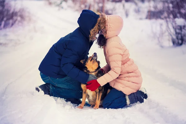 Young couple kissing with dog — Stock Photo, Image