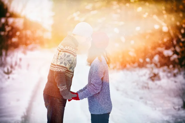 Young couple in love kissing outdoors in snowy winter — Stock Photo, Image