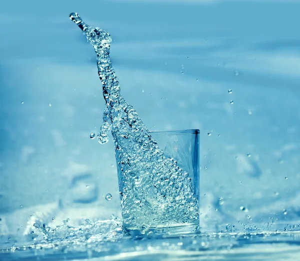 Stream Water Pouring Out Glass Blue Background — Stock Photo, Image