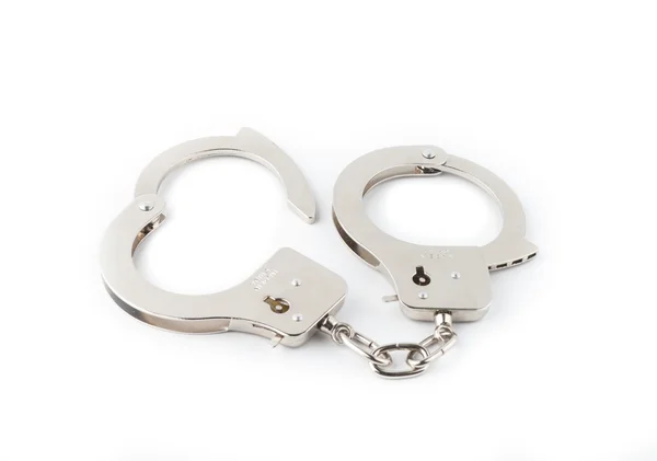 Steel handcuffs on a green background — Stock Photo, Image