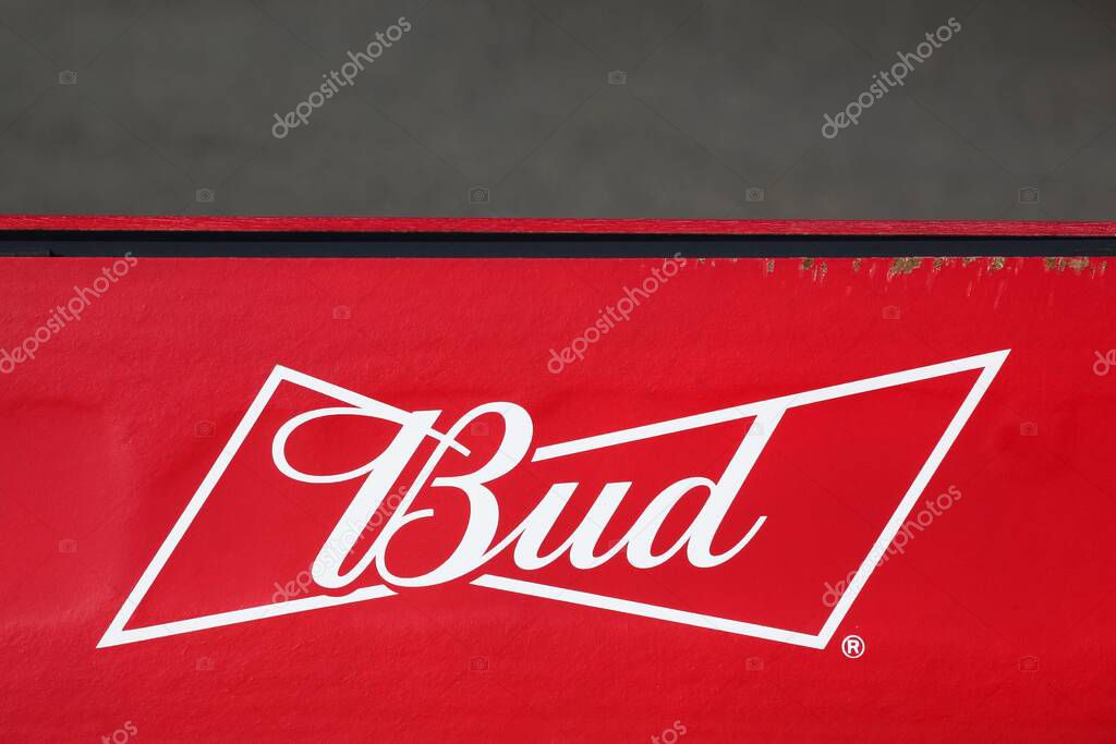 Oingt, France - October 19, 2020: Budweiser logo on a wall. Budweiser is an American-style pale lager produced by Anheuser-Busch, part of AB InBev