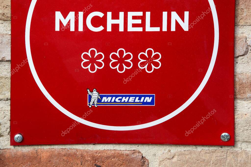 Vonnas, France - February 23, 2017: Michelin restaurant 3 stars symbol on a wall. Michelin guides are a series of guide books published by the French company Michelin for more than a century