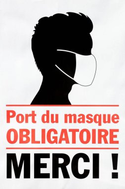 Maske takmak zorunludur. Fransız dilinde port du masque obligatoire merci denilen bir sembol.