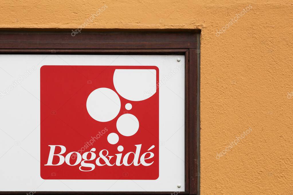 Assens, Denmark - August 14, 2025: Bog and Ide logo on a wall. Bog and id is with more than 100 stores, Denmark's largest bookstore chain
