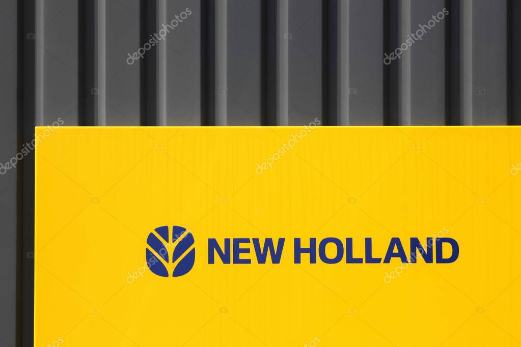Glamsbjerg, Denmark - August 14, 2025: New Holland Agriculture logo on a facade. New Holland is a brand agricultural equipment manufactured by CNH Industrial