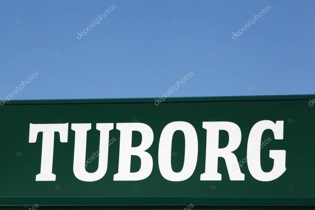 Nyborg, Denmark - July 2, 2022: Tuborg beer logo on a wall. Tuborg is a Danish brewing company founded in 1873 on a harbour in Hellerup, Denmark. Tuborg is a part of Carlsberg group