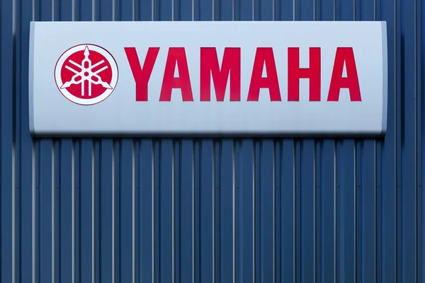 Yamaha logo on a wall of a dealer — стокове фото