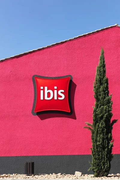 Знак отеля Ibis на красной стене — стоковое фото