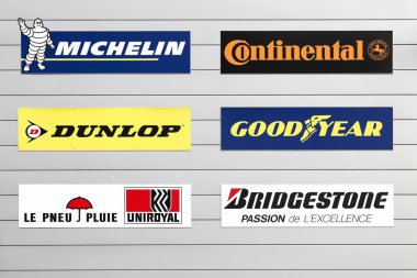 Facade of a store with major tire brands in the world clipart