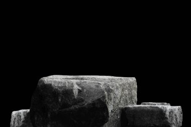 Stone podium on dark black background.	