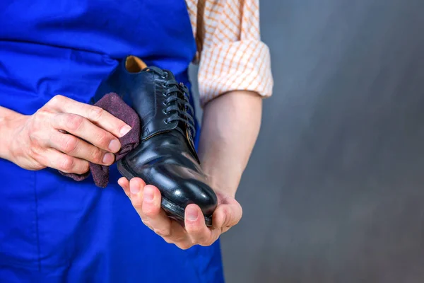 The master is cleaning shoes. Shoemaker