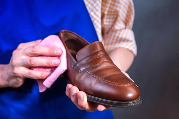 The master is cleaning shoes. Shoemaker