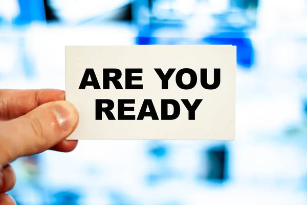 Are You Ready words on a white business card of a businessman.