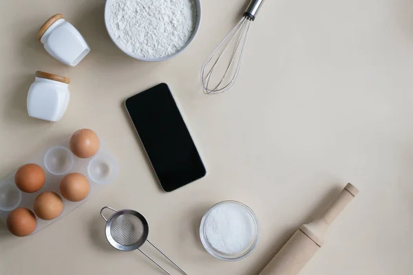 Online cooking courses. The smartphone is among the ingredients for cooking. Top view. Copy space. Horizontal orientation.