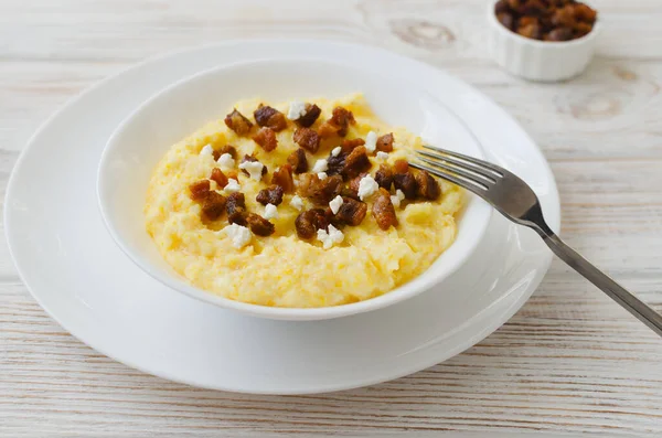 Otantik Hutsul banosh bryndza ve çatırtıları basit bir şekilde servis edilir. Geleneksel Ukrayna Karpatları yemeği konukseverliği, kültürü ve ev yemeklerini sembolize eder..