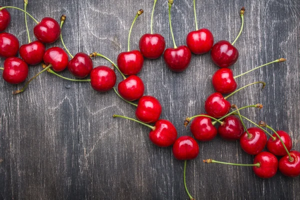 A lot of berries and cherries heart shape — Stock Photo, Image