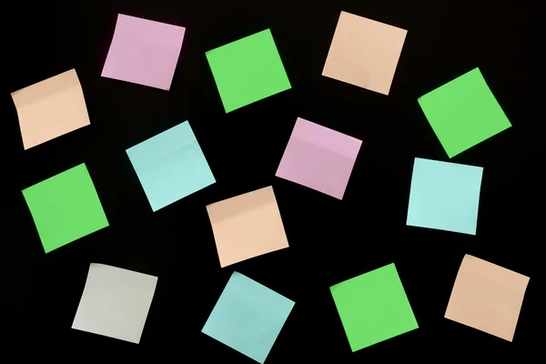 Stickers of different colors on a black background — Stock Photo, Image